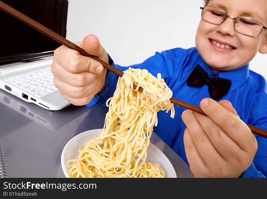 Hungry fat boy eating chinese noodles with sticks