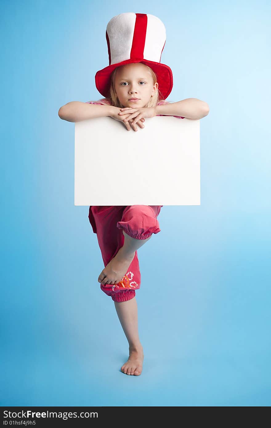 Young girl on one foot standing and holding a empty note. Young girl on one foot standing and holding a empty note