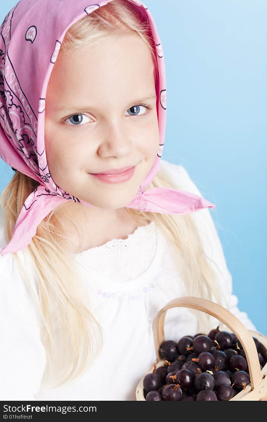 Young country girl with basket filled with berries