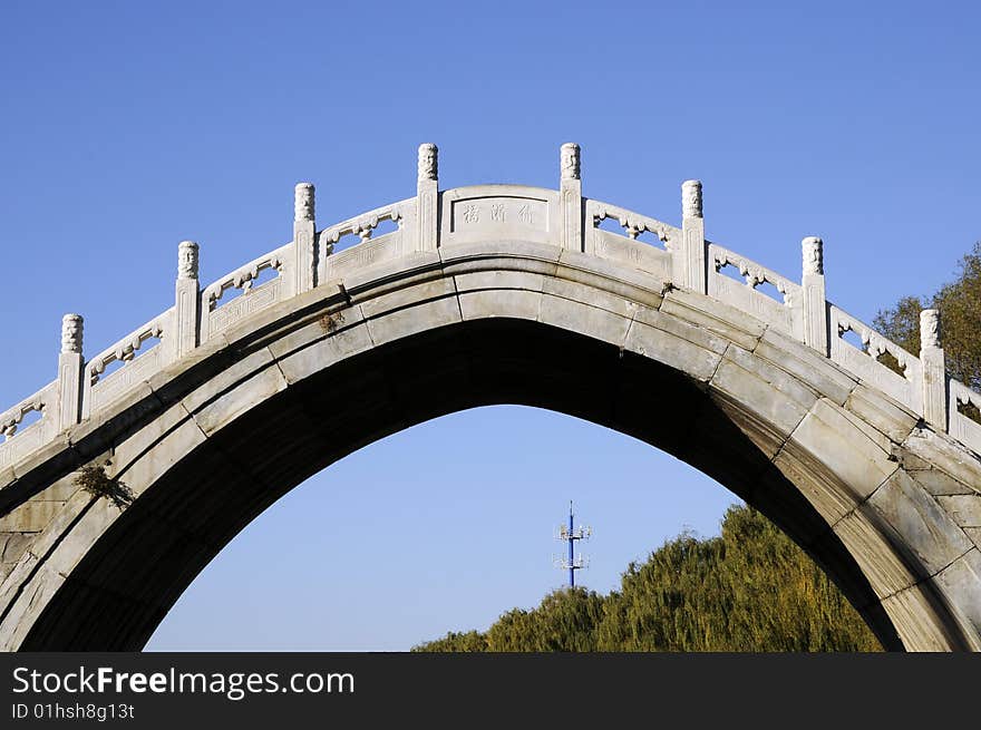 Stone bridge on the lake, ancient bridge building. Stone bridge on the lake, ancient bridge building