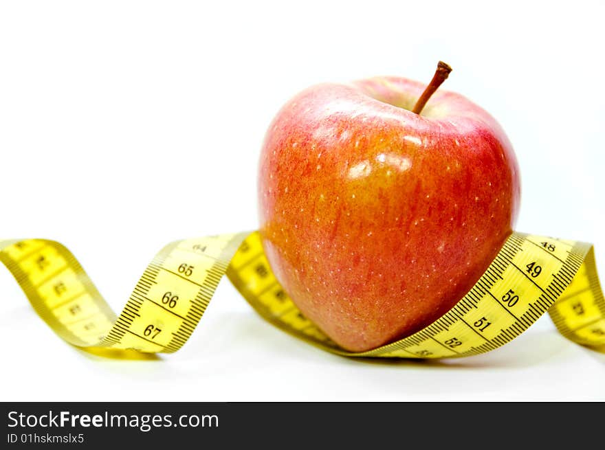 Apple with measuring tape as a symbol for dieting