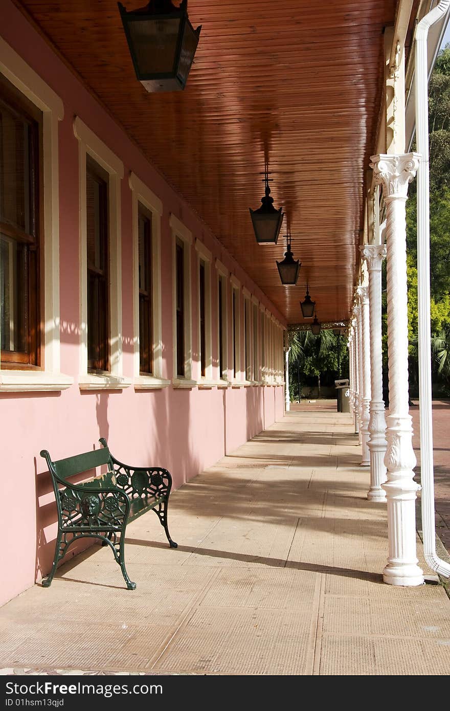 Angled view of the porch of a pink building in an old mining village in_ South Africa