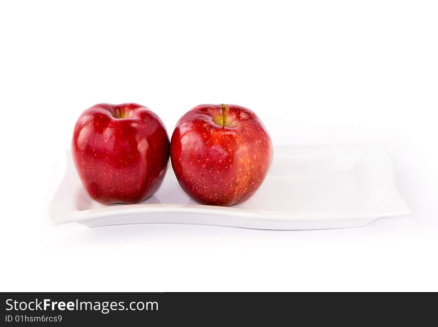 Ripe red apple and plate on white