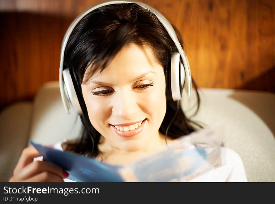 Beautiful woman listening music in headphones