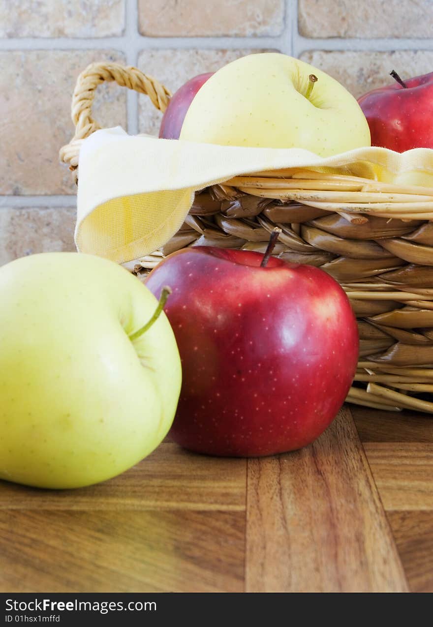 Rustic photo of apples in a wicker basket and next to it