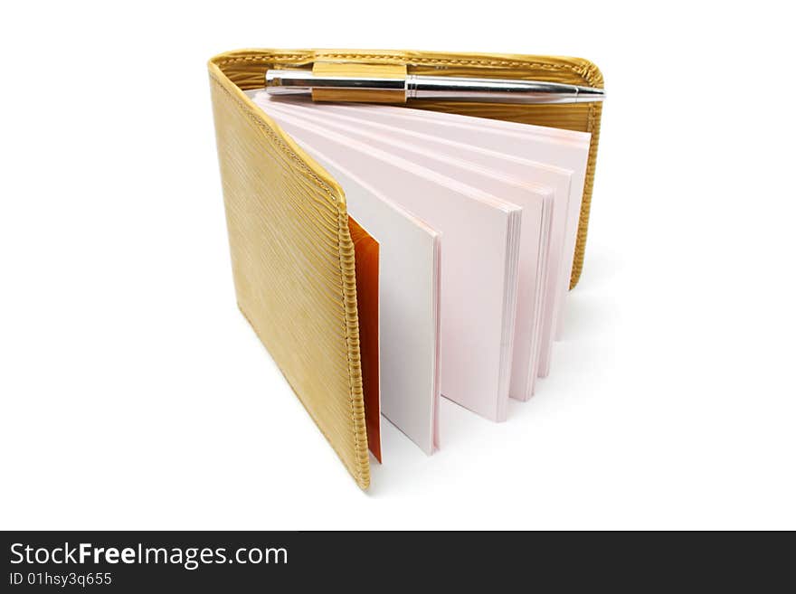 A small notebook with beige cover isolated on white background. A small notebook with beige cover isolated on white background.