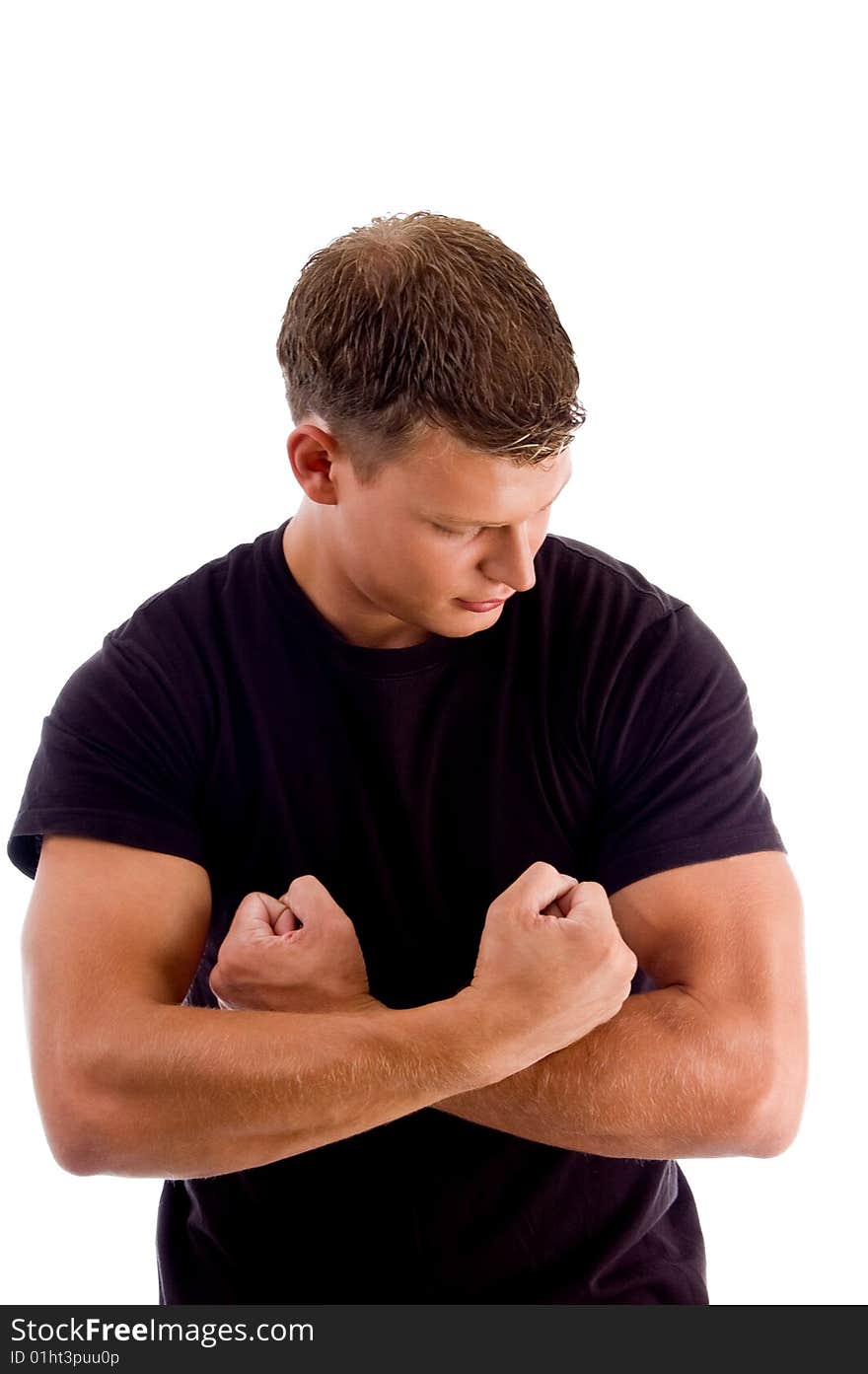 Young man showing his muscles against white background