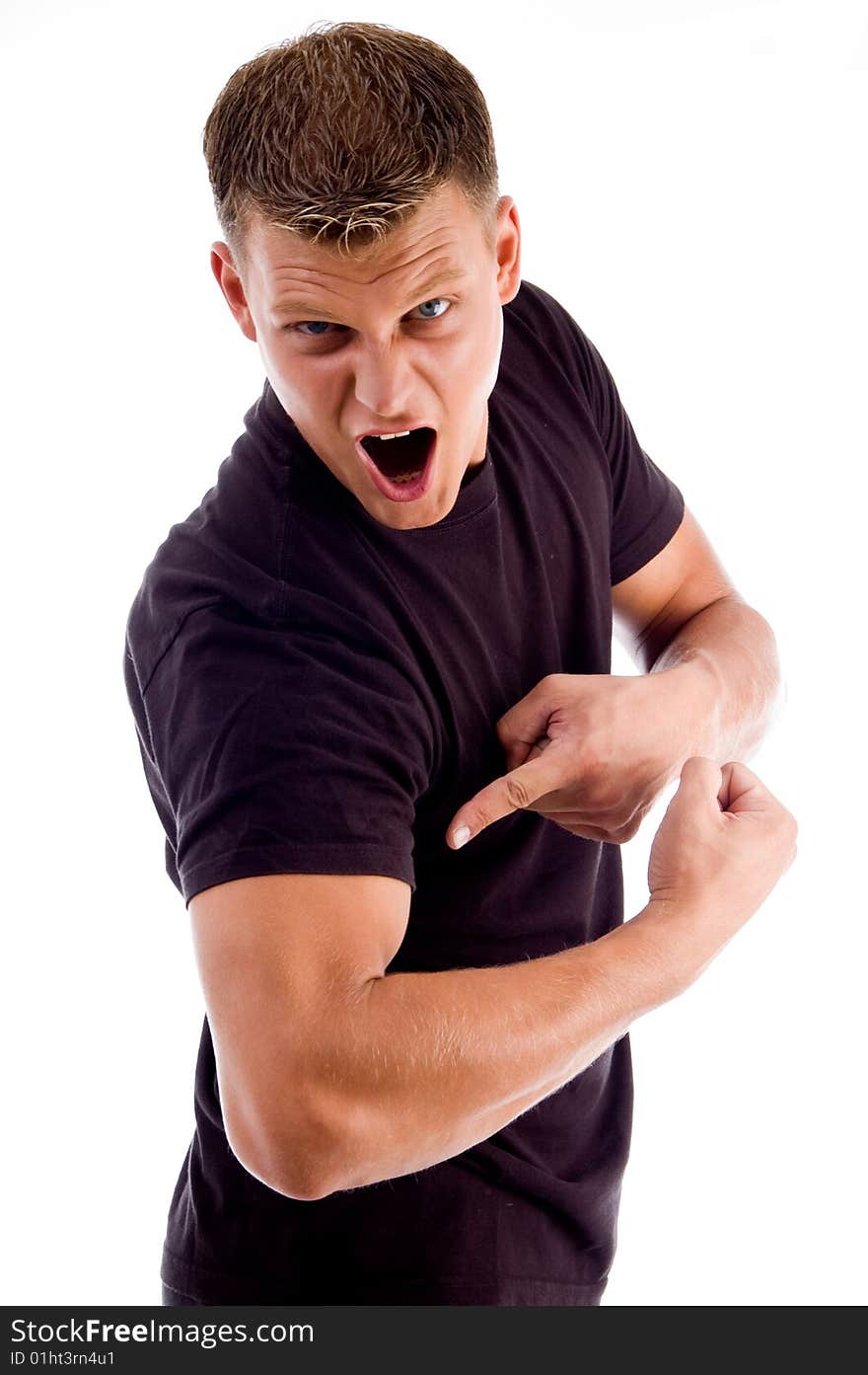 Shouting man pointing at his muscles against white background