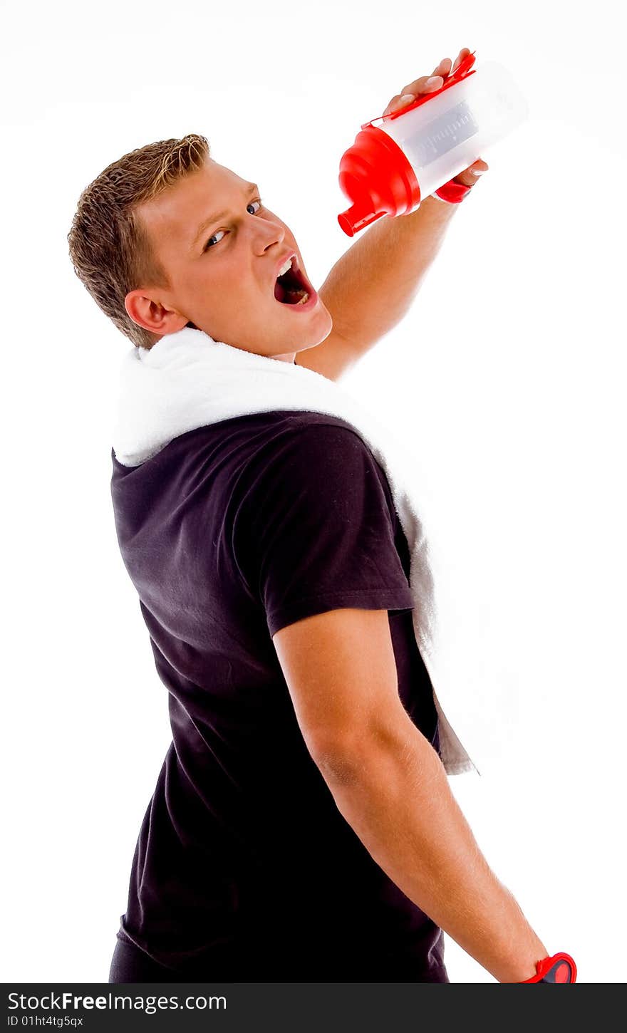 Back pose of muscular man drinking from water bottle on an isolated background