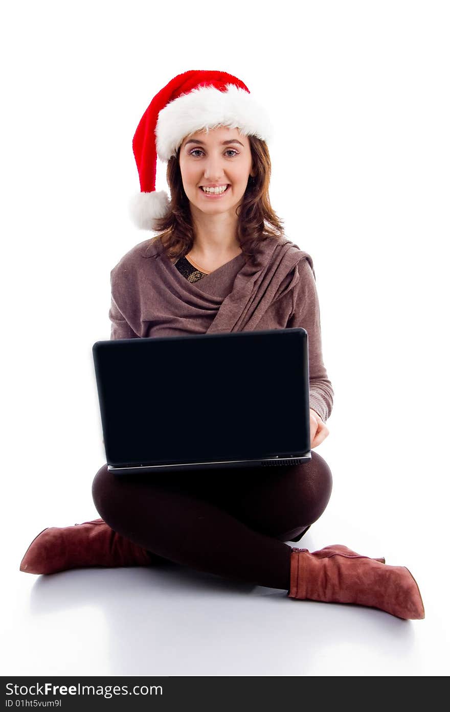 Young woman in christmas hat posing with laptop