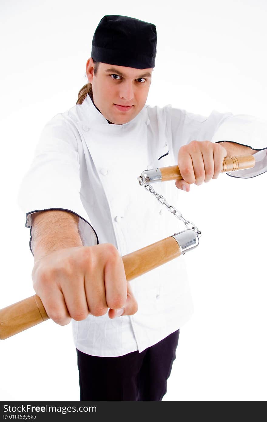 Chef holding nunchaku in fighting stance