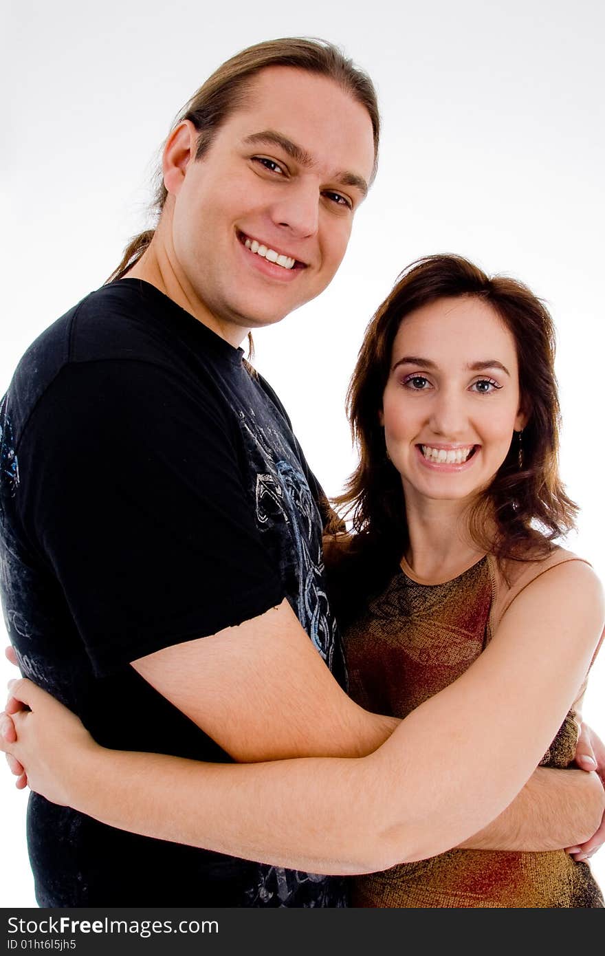 Smiling playful young couple on an isolated white background