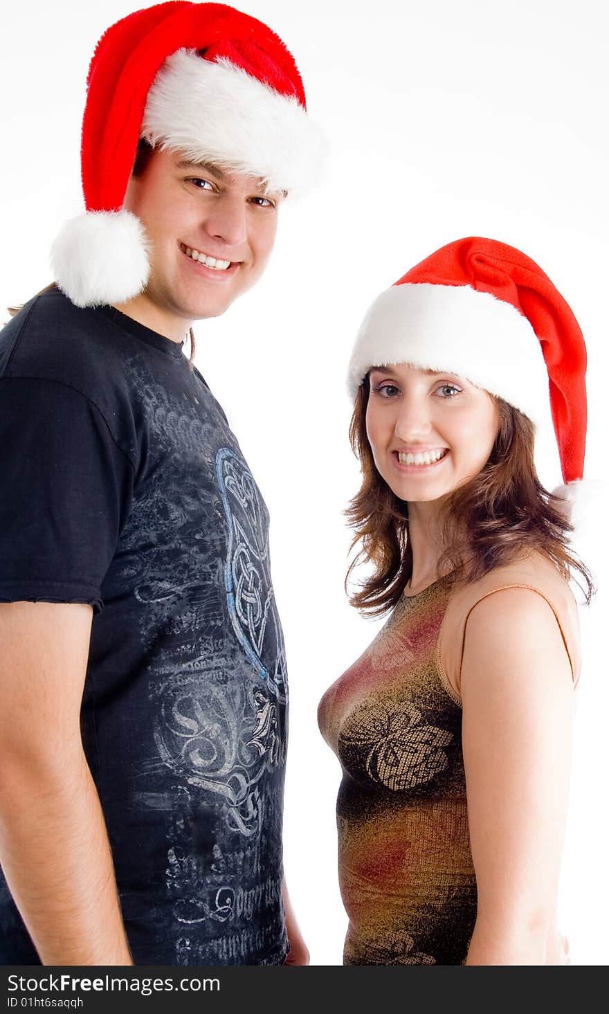 Couple with christmas hat and looking at camera on an isolated background