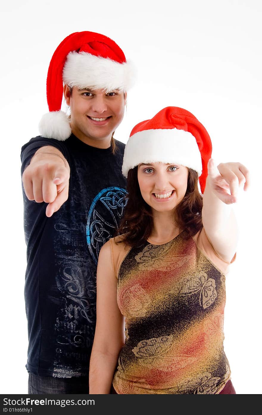 Pointing couple wearing christmas hat