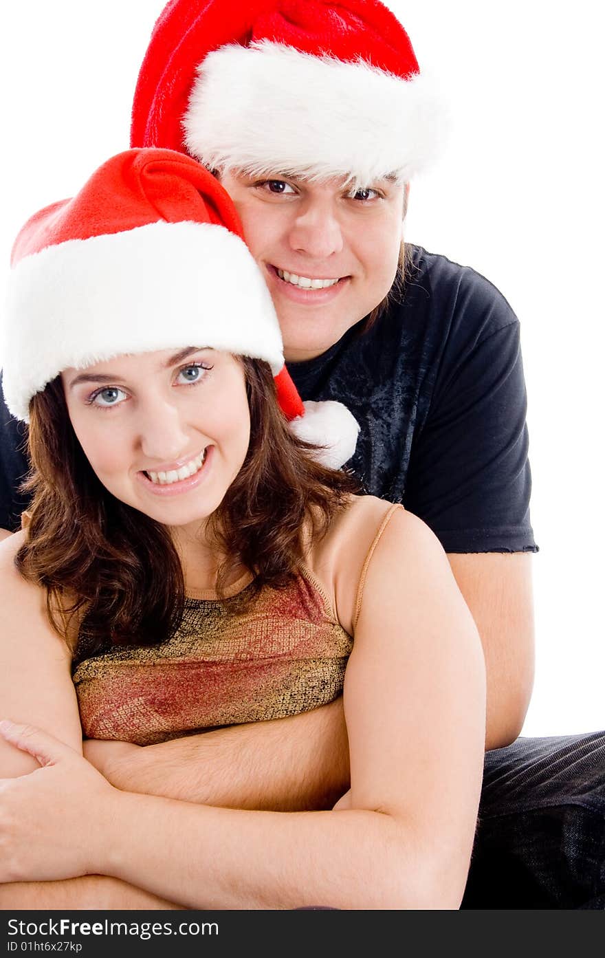 Couple with christmas hat and looking at camera on an isolated white background