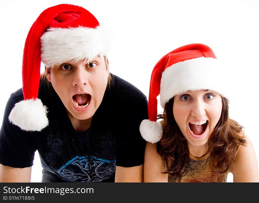 Portrait of shouting couple wearing christmas hat on an isolated background