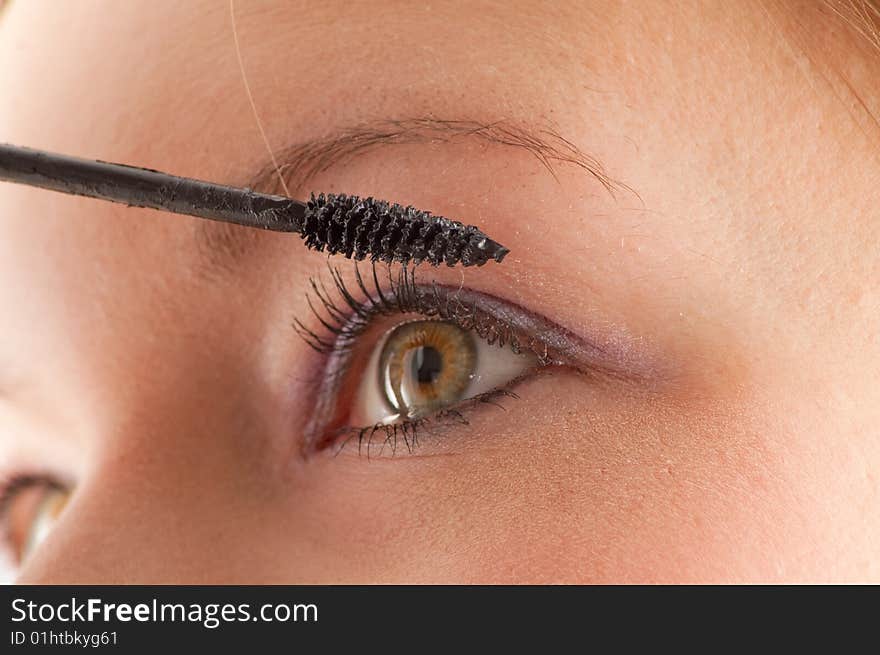 Pretty young girl doing makeup