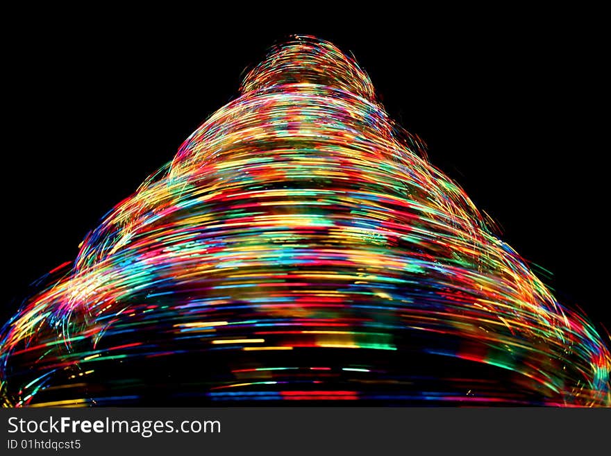 Long exposure photograph looking up at a rotating optical fibre christmas tree with cycling colours. Long exposure photograph looking up at a rotating optical fibre christmas tree with cycling colours.