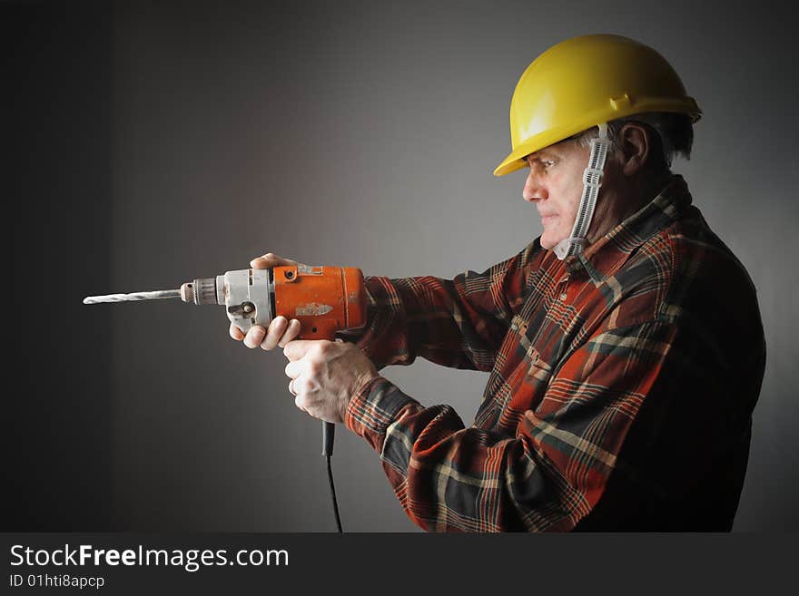 A worker using an electric drill