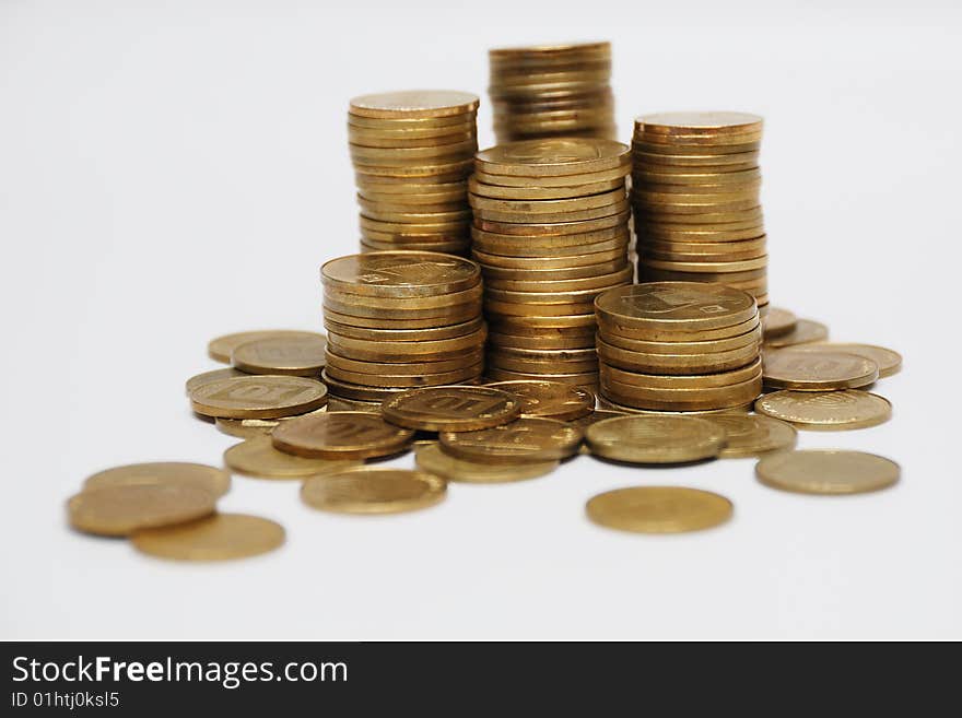 Different coins stacked on white background