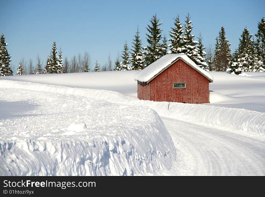 Red cottage by a snowy road. Red cottage by a snowy road