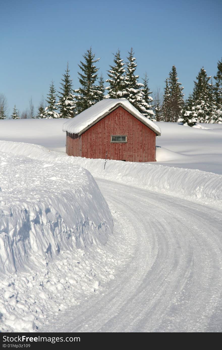 Red cottage by a snowy road. Red cottage by a snowy road