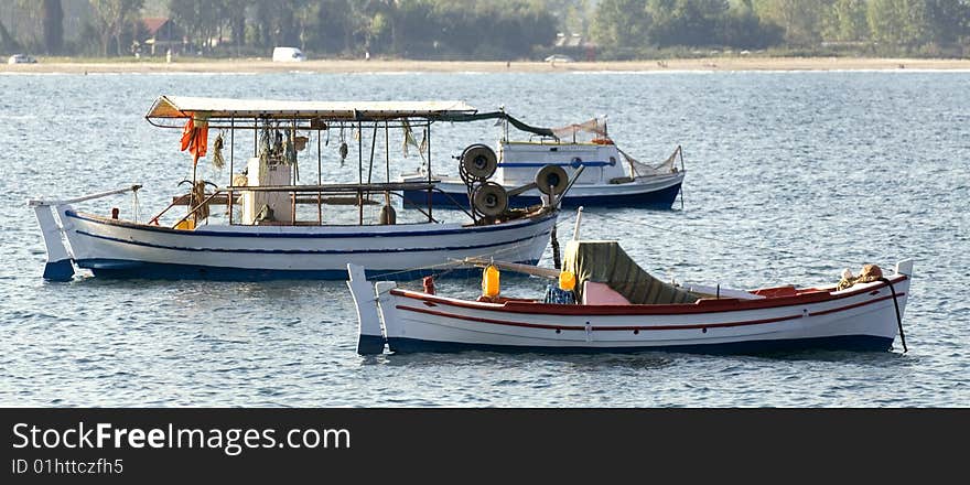 Three fishing boats, coastal scenic