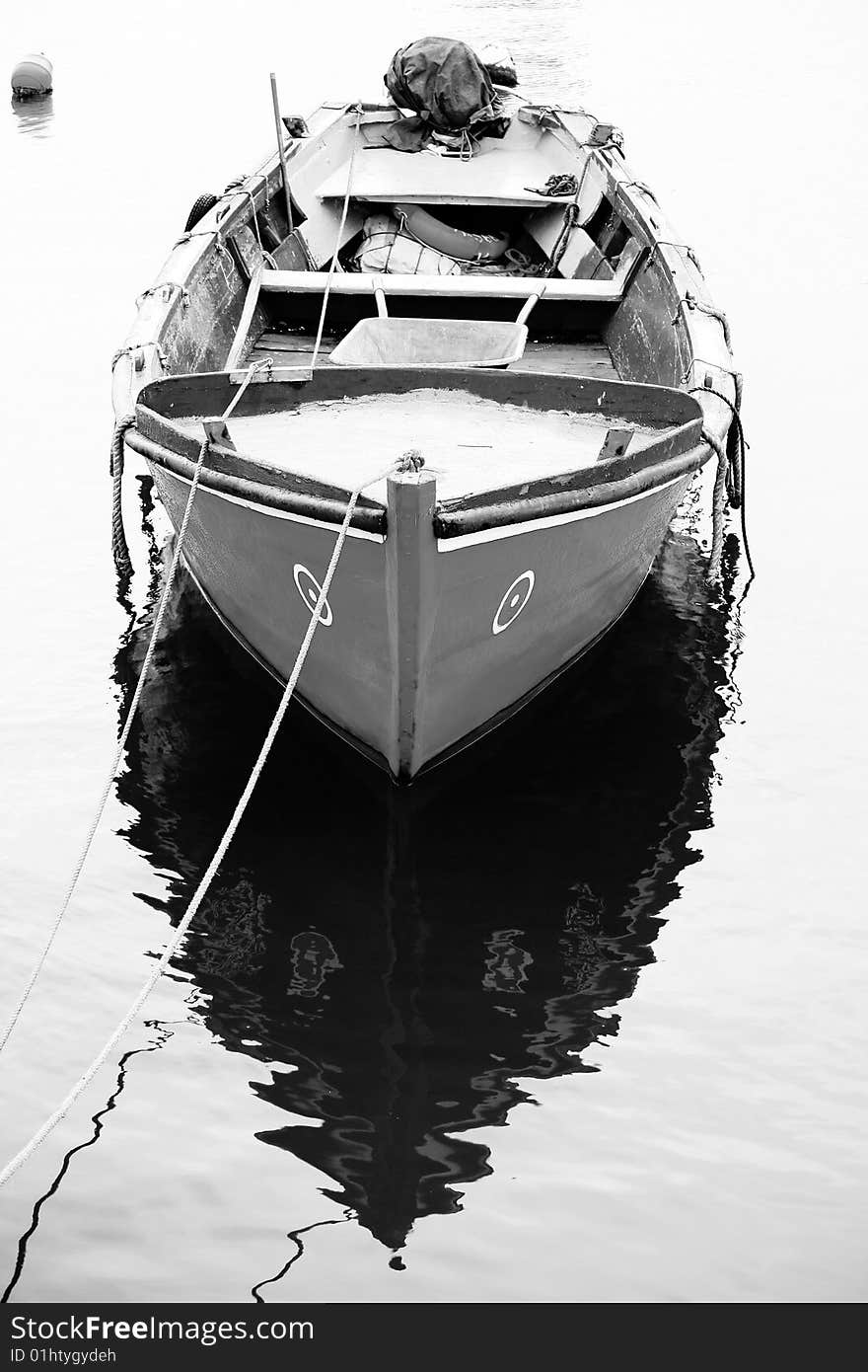 Vertical view of a traditional portuguese fishing boat, anchored on the docks. Vertical view of a traditional portuguese fishing boat, anchored on the docks.