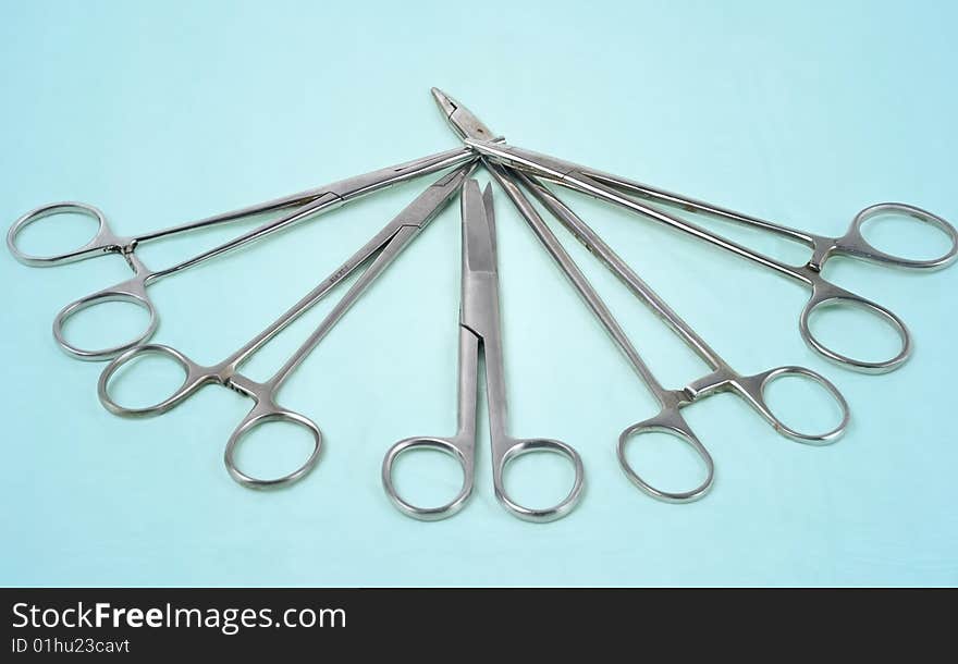 Surgical tools on a light blue background