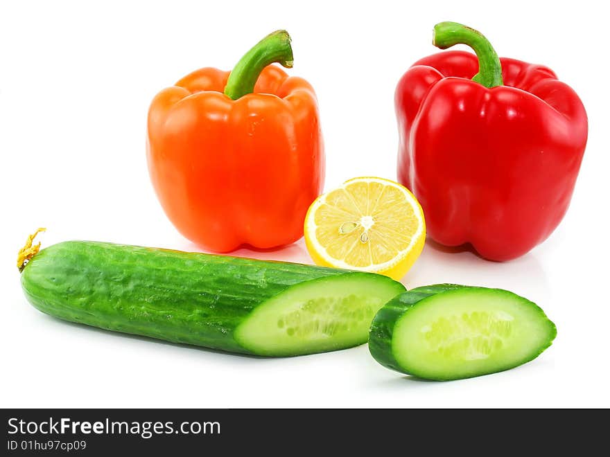 Fresh vegetables fruits (paprika, cucumber and lemon) isolated on a white background. Shot in a studio. Fresh vegetables fruits (paprika, cucumber and lemon) isolated on a white background. Shot in a studio.