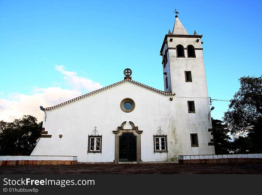 Full frontal view of a small christian church on the village of Barranco do Velho in Algarve, Portugal.