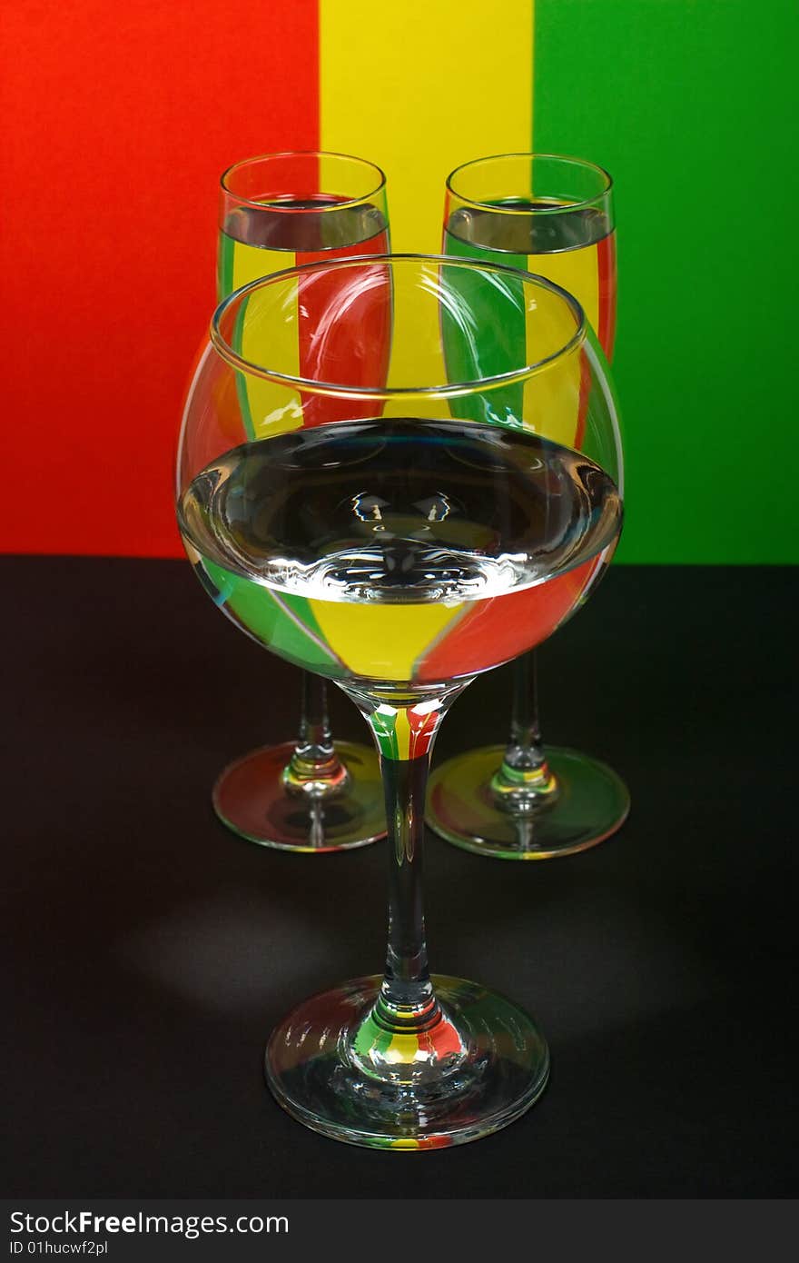 Three wineglass in color background