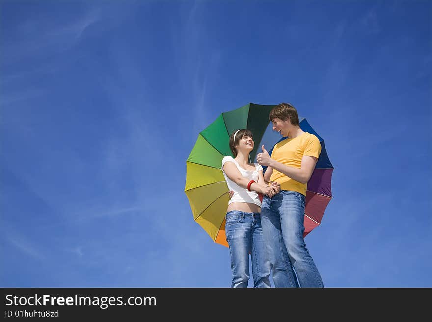 Happy couple under colorful umbrella