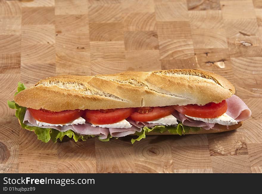 Rustic french baguette with ham and cheese. Rustic french baguette with ham and cheese