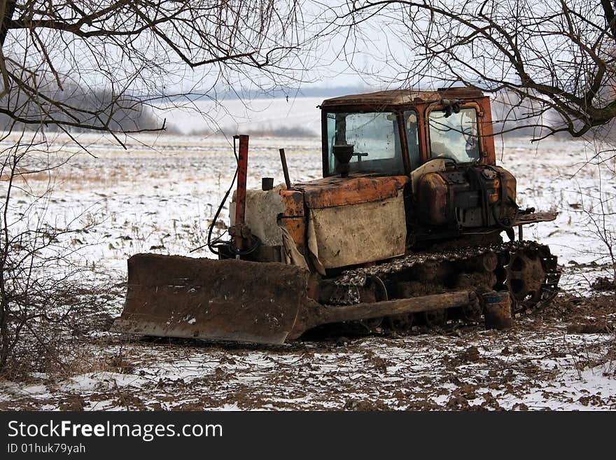 Tractor in the field villages near Buzhanka, Ukraine. By sight very old, but nevertheless works