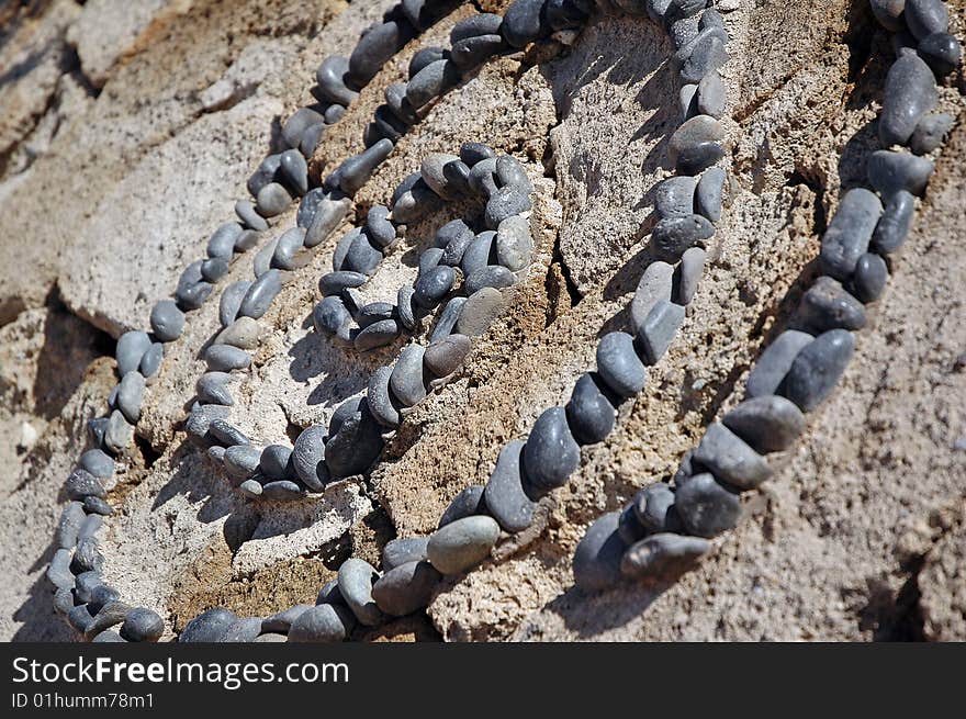 Spiral stone pattern made of small pebbles. Spiral stone pattern made of small pebbles