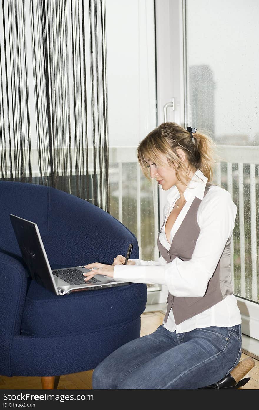 Woman studying at home on a rainy day. Woman studying at home on a rainy day