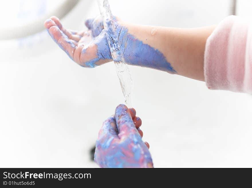Child washing a blue hands
