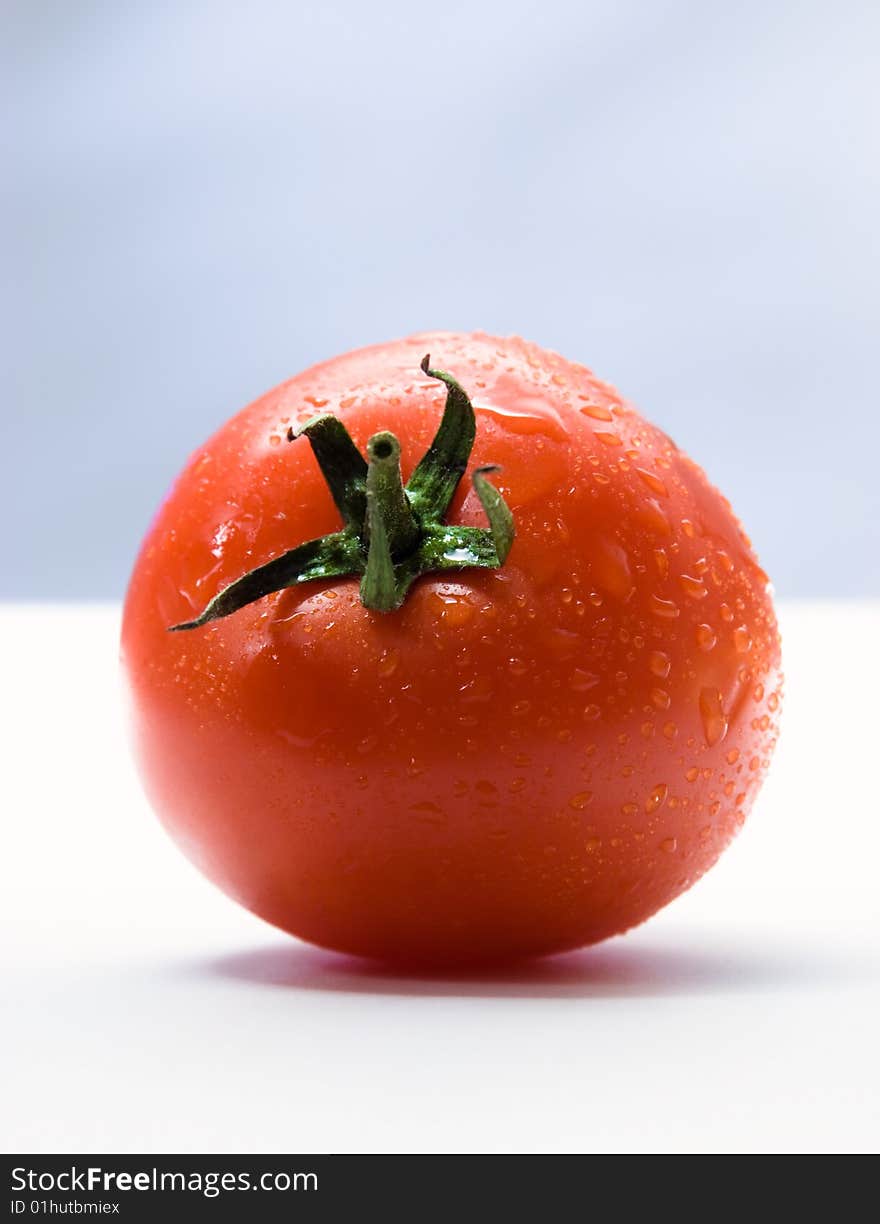 Tomato with drops. On white. Tomato with drops. On white