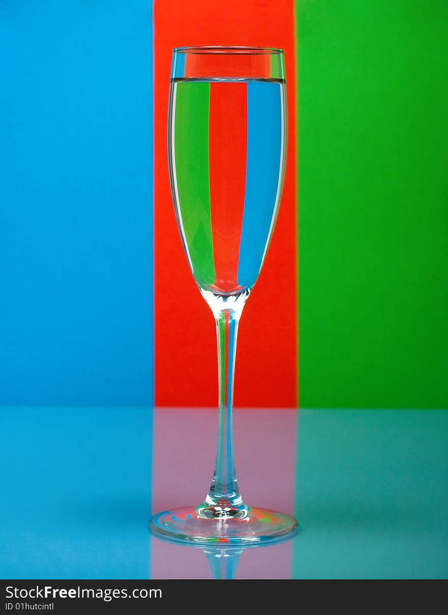 One wineglass on color background