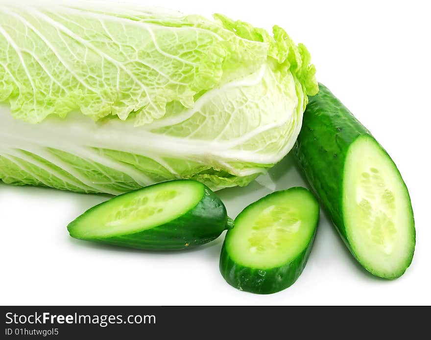 Fresh vegetables (chinese cabbage and sliced cucumber) isolated on a white background. Shot in studio. Fresh vegetables (chinese cabbage and sliced cucumber) isolated on a white background. Shot in studio