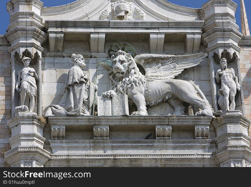 A Lion and holy man sculpture on Italian building. A Lion and holy man sculpture on Italian building