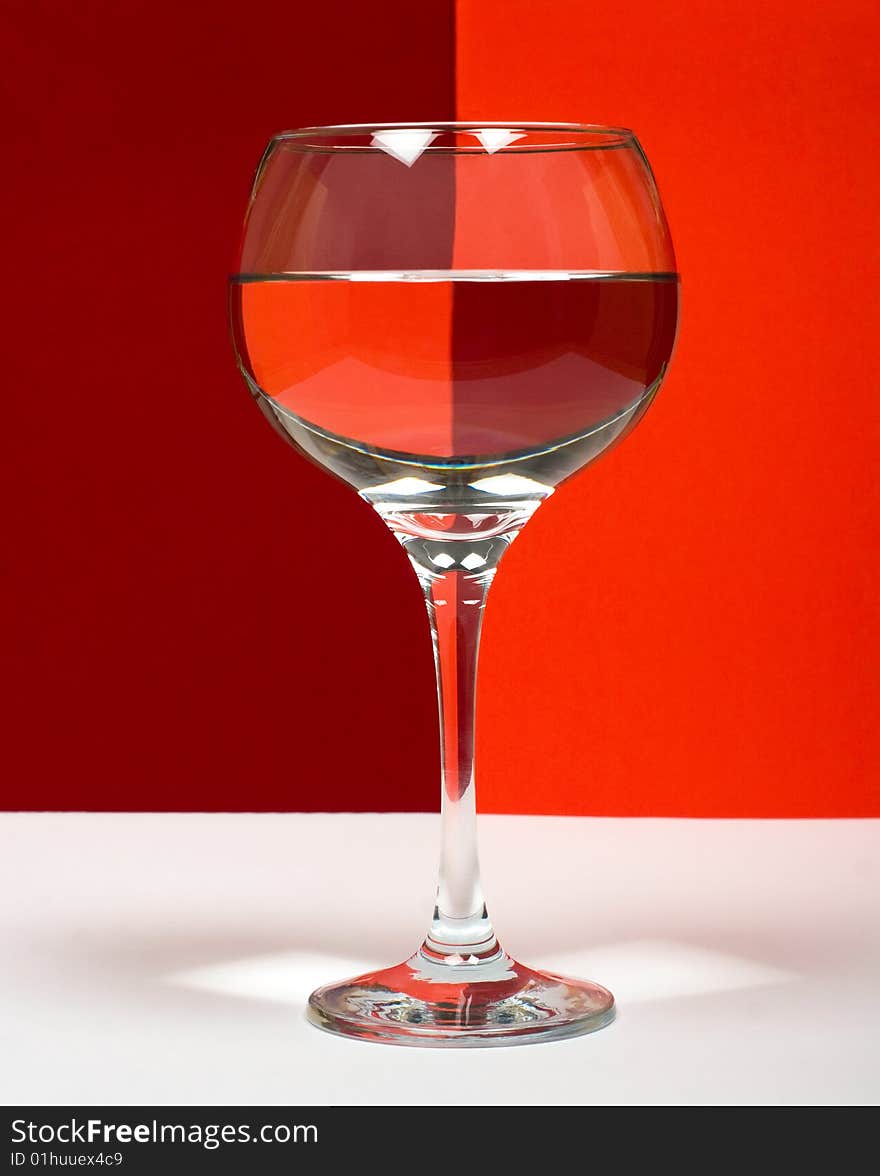 One wineglass in color background