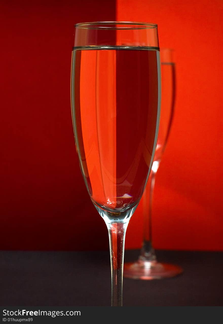 Two wineglass in color background