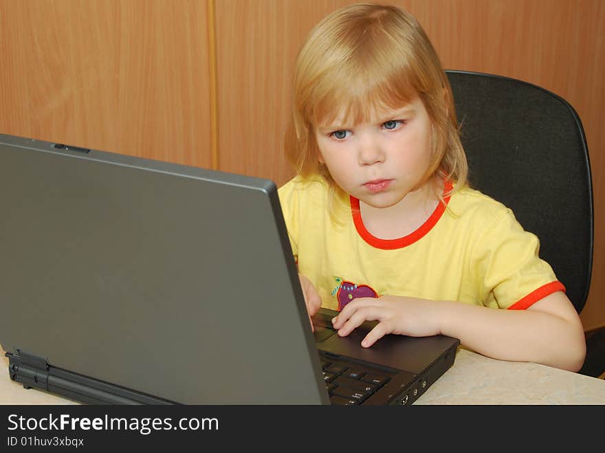 Little girl at table with notebook. Little girl at table with notebook