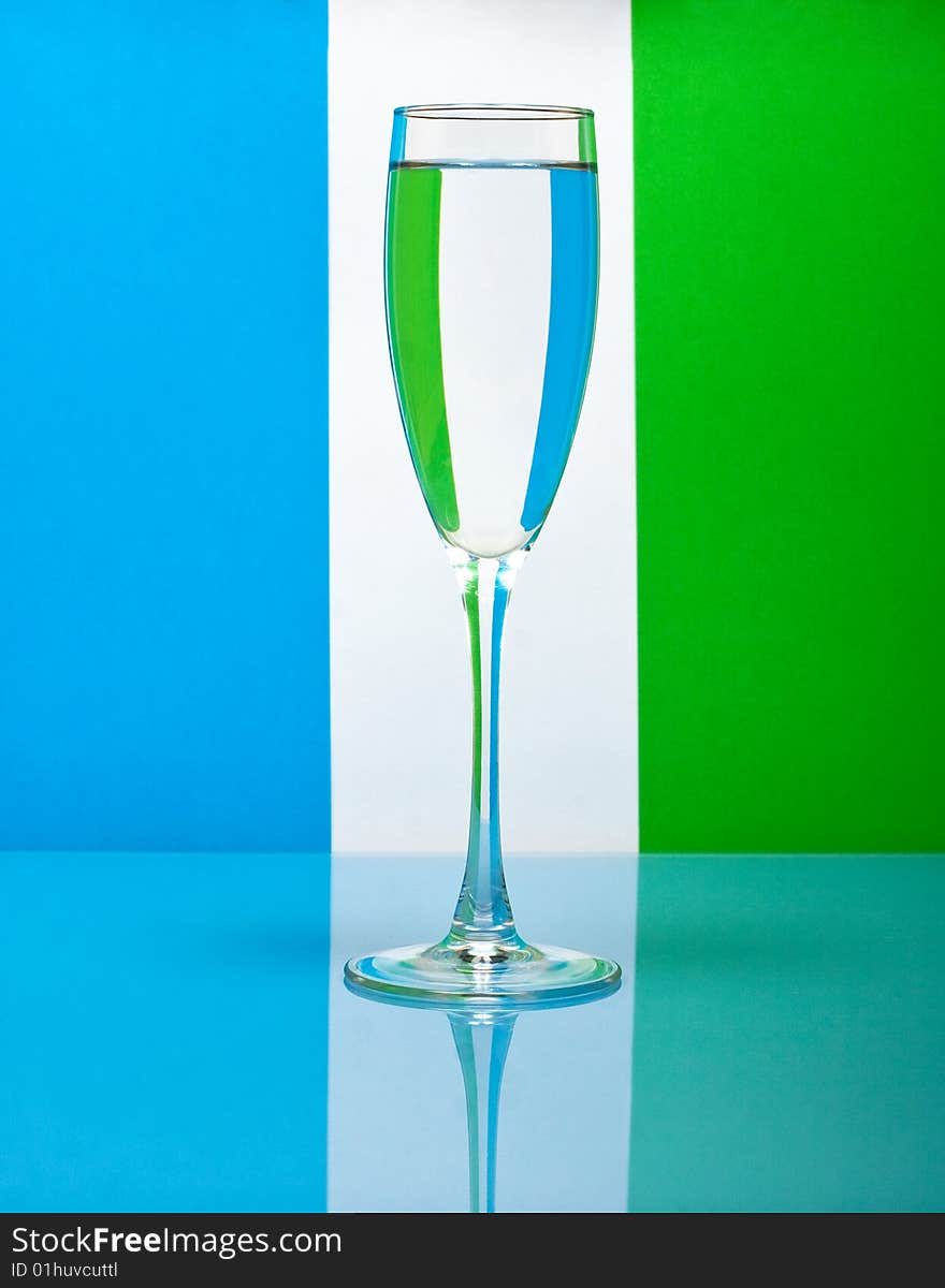 One wineglass on color background