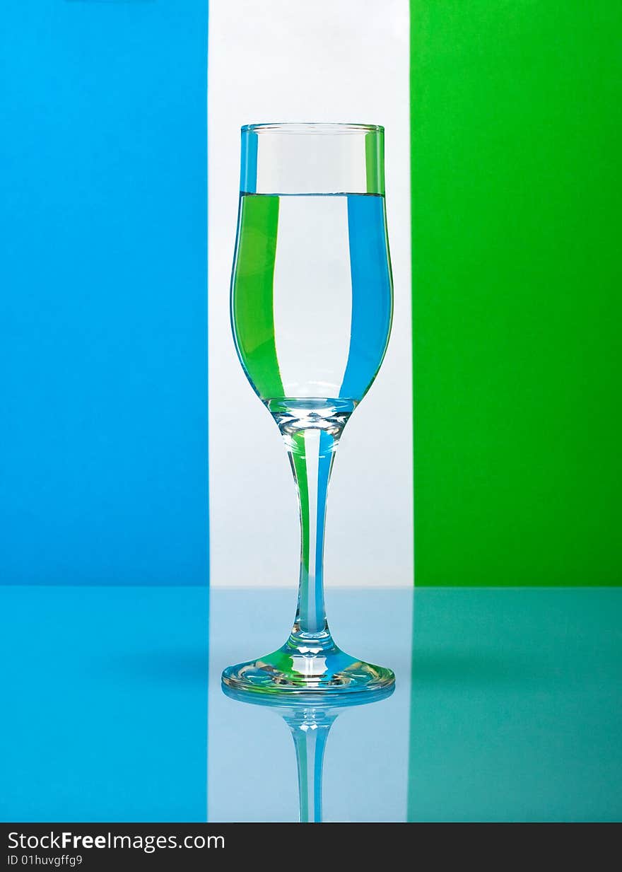 One wineglass on color background