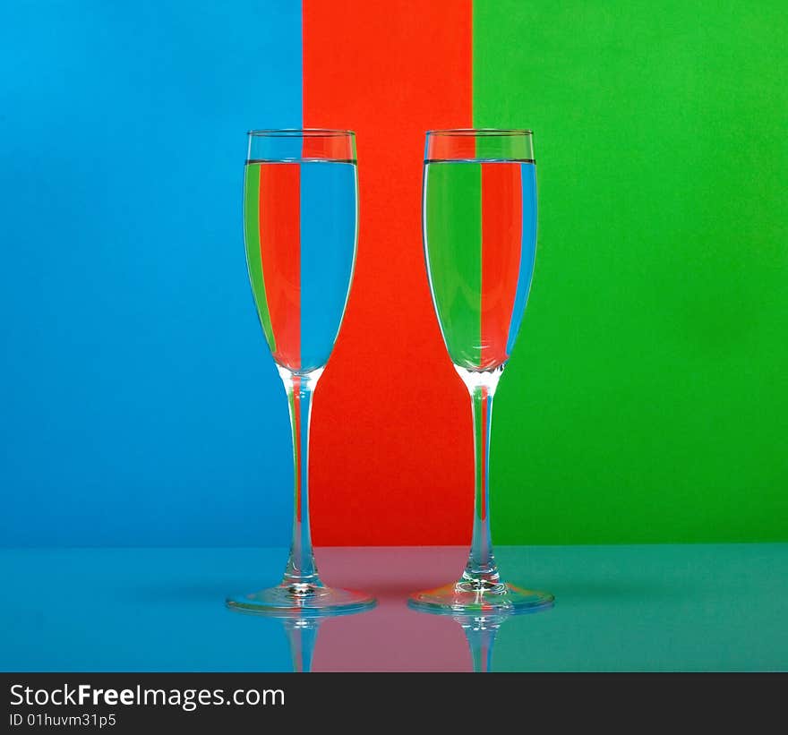 Two wineglass in color background