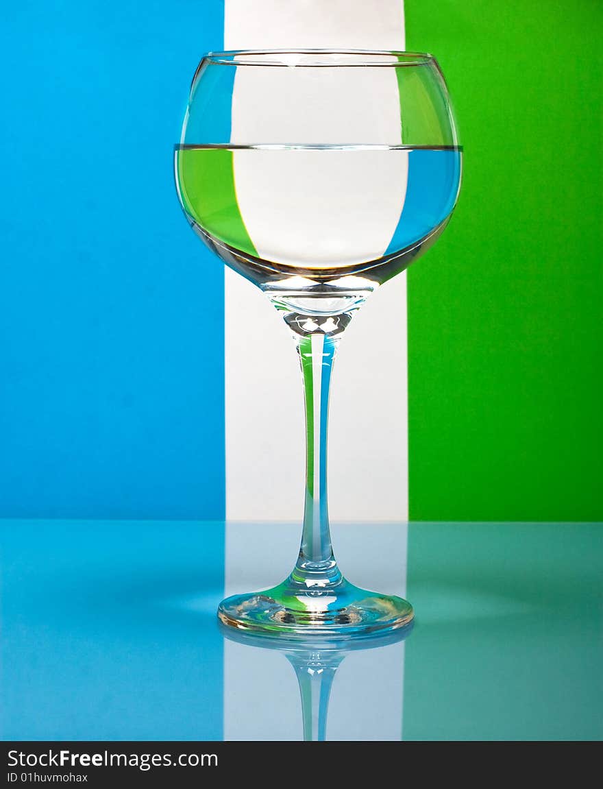 One wineglass in color background