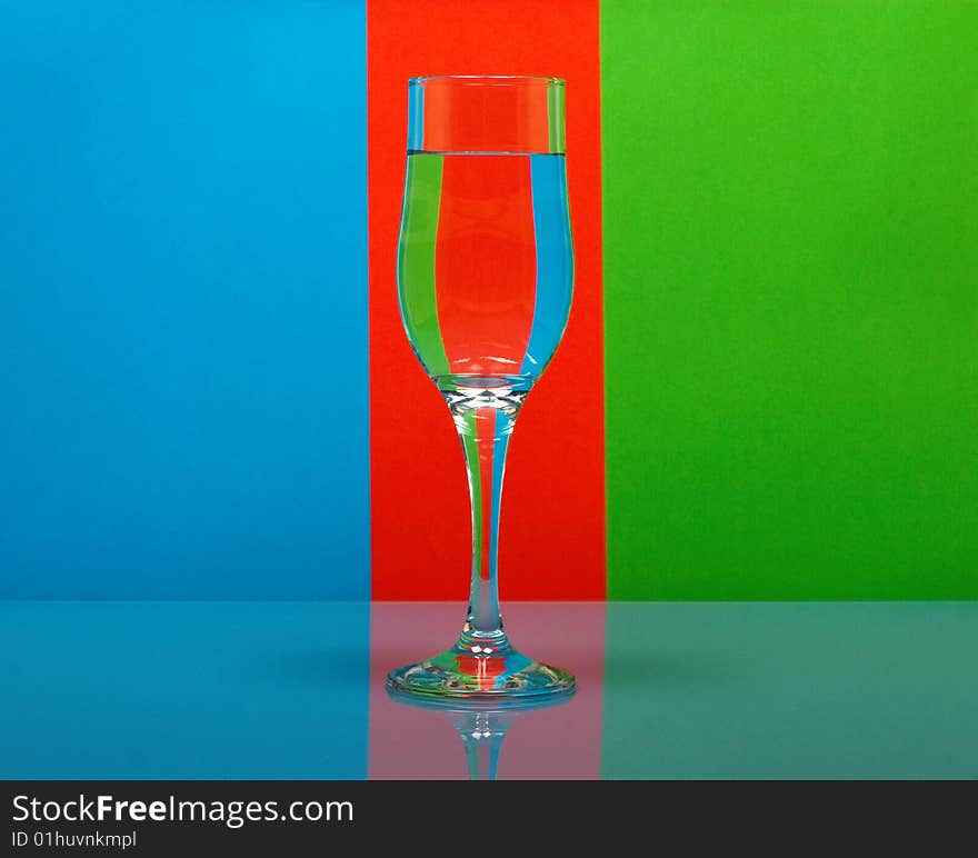 One wineglass on color background